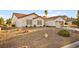 View of a single-story home featuring a tile roof, desert landscaping, and an attached two-car garage at 5009 Elm Grove Dr, Las Vegas, NV 89130