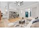 A staged living room with a neutral color palette, wood floors, and an open floor plan to the kitchen at 5009 Elm Grove Dr, Las Vegas, NV 89130