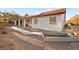 The house features a terracotta roof, solar panels, and a large gravel yard at 5009 Elm Grove Dr, Las Vegas, NV 89130