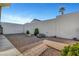 Low-maintenance backyard featuring decorative rock and mature landscaping at 602 Paloma Dr, Boulder City, NV 89005