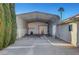 Large backyard featuring a covered metal storage and parking area alongside a stucco home exterior at 602 Paloma Dr, Boulder City, NV 89005