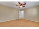 Bedroom with wood-look floors, ceiling fan, and white door at 602 Paloma Dr, Boulder City, NV 89005