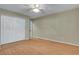 Bedroom with wood-look floors, ceiling fan, and double door closet at 602 Paloma Dr, Boulder City, NV 89005
