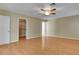 Bedroom with wood-look floors, ceiling fan, closet, and white door at 602 Paloma Dr, Boulder City, NV 89005