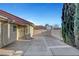 Long concrete driveway leading to a gated backyard area at 602 Paloma Dr, Boulder City, NV 89005