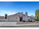 Charming single-story home featuring a desert landscaped yard, red tile roof, and attached two-car garage at 602 Paloma Dr, Boulder City, NV 89005