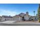 Charming single-story home featuring a desert landscaped yard, red tile roof, and attached two-car garage at 602 Paloma Dr, Boulder City, NV 89005
