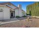 Inviting front entrance with security gate and well-maintained desert landscaping at 602 Paloma Dr, Boulder City, NV 89005