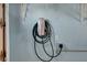 Garage with a wall-mounted Tesla charger and electrical outlets at 602 Paloma Dr, Boulder City, NV 89005
