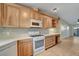 Updated kitchen featuring stainless steel appliances, custom cabinets, and a tiled backsplash at 602 Paloma Dr, Boulder City, NV 89005