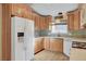 Well-lit kitchen with white appliances, wood cabinets, and lots of counter space at 602 Paloma Dr, Boulder City, NV 89005