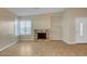 Cozy living room with a brick fireplace and large windows providing natural light at 602 Paloma Dr, Boulder City, NV 89005