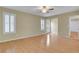 Bright living area with wood floors, ceiling fan, and natural light streaming from white shuttered windows at 602 Paloma Dr, Boulder City, NV 89005
