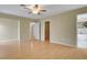 Spacious main bedroom with wood-look flooring, ceiling fan, walk-in closet, and bathroom access at 602 Paloma Dr, Boulder City, NV 89005