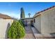 Charming side yard with mature greenery and a covered carport at 602 Paloma Dr, Boulder City, NV 89005