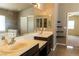 Elegant bathroom featuring double sinks, dark wood cabinets, and ample counter space at 629 Bright Lights Ave, North Las Vegas, NV 89031
