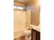 Bathroom featuring a combined tub and shower with a stylish dark cabinet at 629 Bright Lights Ave, North Las Vegas, NV 89031