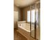 Clean bathroom featuring a tub with shower, a window with blinds, and neutral color palette at 629 Bright Lights Ave, North Las Vegas, NV 89031