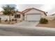 Charming single-story home featuring a red tile roof, neutral stucco, and a two-car garage at 629 Bright Lights Ave, North Las Vegas, NV 89031