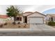 Charming single-story home with a red tile roof, neutral stucco, and a two-car garage at 629 Bright Lights Ave, North Las Vegas, NV 89031