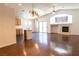 Open-concept living space with hardwood floors, a fireplace, and seamless transition to the kitchen at 629 Bright Lights Ave, North Las Vegas, NV 89031