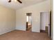 Cozy primary bedroom with an en-suite bathroom, carpet flooring, and neutral tones at 629 Bright Lights Ave, North Las Vegas, NV 89031