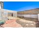 Backyard featuring a lattice-covered patio, brick trim, rocks, and a cinder block privacy fence at 6741 Bonillo Dr, Las Vegas, NV 89103