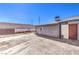 Backyard featuring a concrete patio, cinder block privacy fence, and gray storage building at 6741 Bonillo Dr, Las Vegas, NV 89103