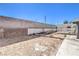 Backyard featuring a lattice-covered patio, cinder block privacy fence, and gravel at 6741 Bonillo Dr, Las Vegas, NV 89103