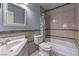 Tiled bathroom with a shower-tub combo, toilet, and a sink with a large mirror above at 6741 Bonillo Dr, Las Vegas, NV 89103
