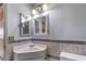 Tiled bathroom with a sink and medicine cabinet at 6741 Bonillo Dr, Las Vegas, NV 89103
