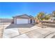 Single-story home with a two-car garage and extended driveway, offering ample parking and curb appeal at 6741 Bonillo Dr, Las Vegas, NV 89103