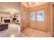 Inviting foyer featuring tiled flooring and decorative double doors, leading into a cozy living space at 6741 Bonillo Dr, Las Vegas, NV 89103