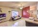 Cozy living room with tiled flooring, a textured accent wall, and comfortable furnishings at 6741 Bonillo Dr, Las Vegas, NV 89103