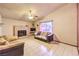 Comfortable living room with tiled floors, a cozy fireplace, and ample natural light at 6741 Bonillo Dr, Las Vegas, NV 89103