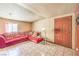 Cozy living room with a red sectional sofa and tile flooring at 6741 Bonillo Dr, Las Vegas, NV 89103