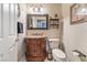 Elegant powder room featuring a decorative mirror, stylish vanity, and neutral decor at 7600 Pleasant Colony Ct, Las Vegas, NV 89131