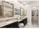 A spacious bathroom featuring double sinks, a vanity area, and a separate shower and luxurious countertops at 7763 Brisk Ocean Ave, Las Vegas, NV 89178