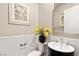 Elegant powder room features a stylish vanity, decorative mirror, and tasteful floral arrangement at 7763 Brisk Ocean Ave, Las Vegas, NV 89178