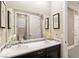Well-lit bathroom with double vanity sinks, sleek countertops, and stylish mirrors in a modern design at 7763 Brisk Ocean Ave, Las Vegas, NV 89178