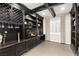 Entertainment room with wine storage, custom built-ins, and a large screen TV at 7763 Brisk Ocean Ave, Las Vegas, NV 89178