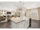 Stylish kitchen with island seating and seamless flow into the living area at 7763 Brisk Ocean Ave, Las Vegas, NV 89178