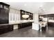 Modern kitchen with dark wood cabinets, a large island, and stainless steel appliances at 7763 Brisk Ocean Ave, Las Vegas, NV 89178