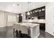 Elegant kitchen featuring dark cabinetry, stainless steel appliances, and a large center island with seating at 7763 Brisk Ocean Ave, Las Vegas, NV 89178