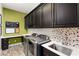 Functional laundry room with modern washer and dryer, ample cabinet space, and a convenient countertop at 7763 Brisk Ocean Ave, Las Vegas, NV 89178