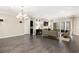 Bright living room features hardwood flooring, a cozy fireplace, ample lighting, and sliding glass doors to the patio at 7763 Brisk Ocean Ave, Las Vegas, NV 89178