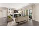 Inviting living room with fireplace, neutral decor, hardwood flooring, and sliding glass doors to the outdoor patio at 7763 Brisk Ocean Ave, Las Vegas, NV 89178