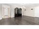 Elegant living room features dark hardwood floors, statement lighting and dark wood hutch at 7763 Brisk Ocean Ave, Las Vegas, NV 89178