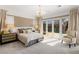 Serene main bedroom with a king-sized bed, plush carpeting, and access to the outdoor pool area at 7763 Brisk Ocean Ave, Las Vegas, NV 89178