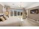 Bright main bedroom with outdoor access, a ceiling fan, and ample sunlight to create a welcoming retreat at 7763 Brisk Ocean Ave, Las Vegas, NV 89178